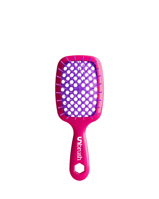 Vibrant Pink Unbrush Mini detangling brush with vibrant purple hexagon bristle pattern, designed for gentle use on wet or dry hair.