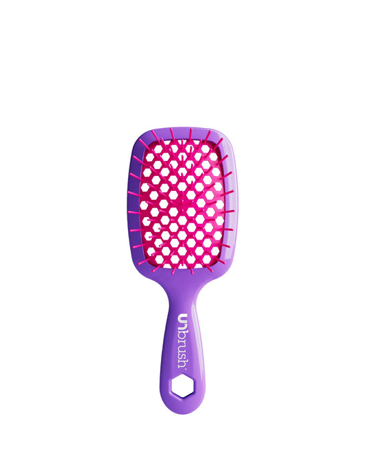 Vibrant Purple Unbrush Mini detangling brush with vibrant pink hexagon bristle pattern, designed for gentle use on wet or dry hair.