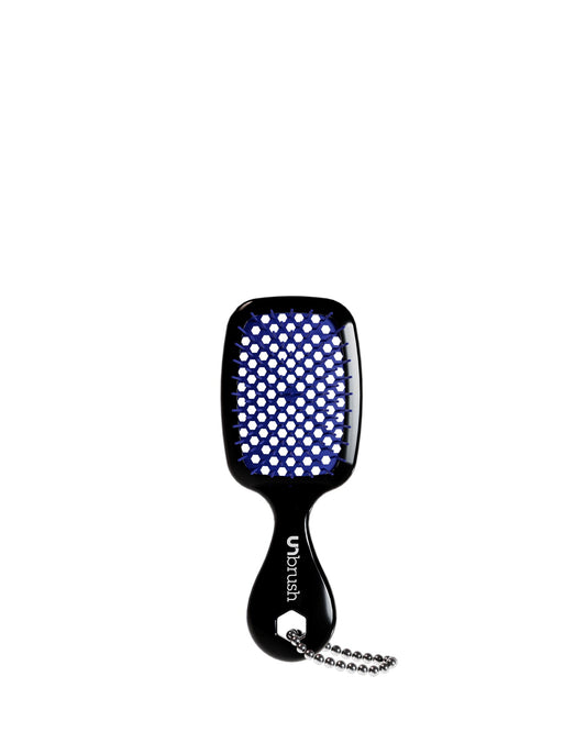 A black UNbrush keychain with blue bristles, featuring a handle and chain.